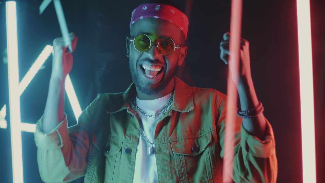 Stylish Man Posing in Neon Lights