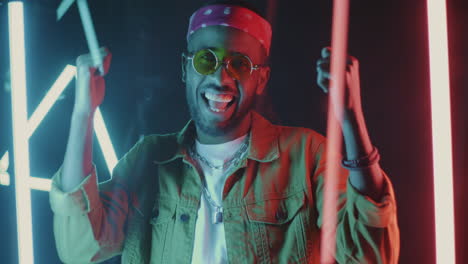 stylish man posing in neon lights