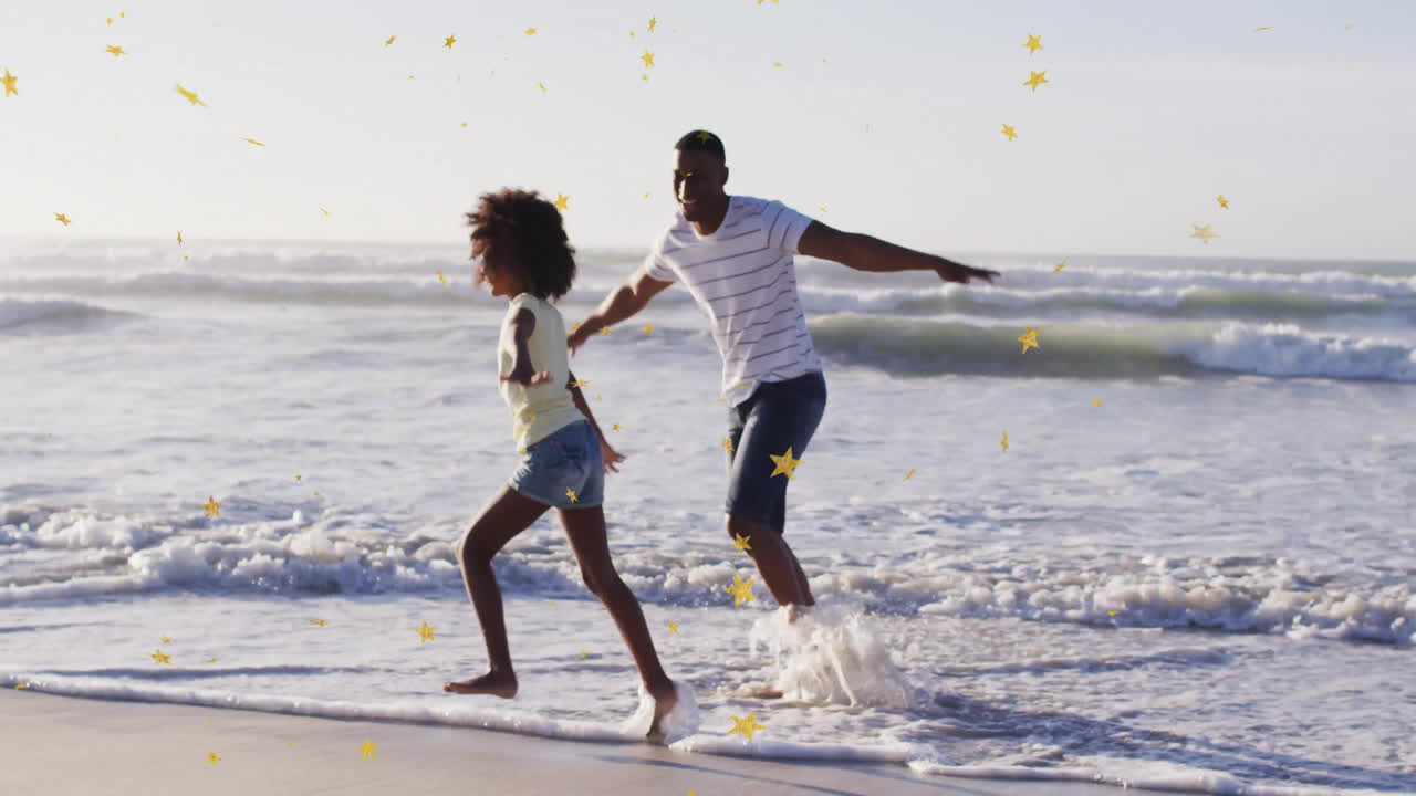 Father and daughter joyfully playing on beach with star animation overlay