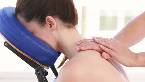 physiotherapist doing back massage to her patient