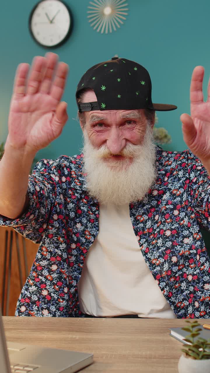 Happy senior man waves hand hi hello gesture greeting welcomes someone online webinar conversation