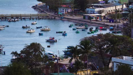 Coracle-and-fishing-boats-anchored-in-serene-Vinh-Hy-bay-harbor,-Vietnam