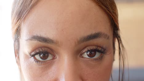 portrait close up of happy unaltered biracial woman taking a break at gym, slow motion