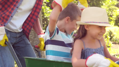 Father-holding-his-children-in-a-wheelbarrow