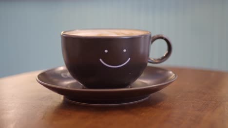 closeup of a cup of coffee with a smiley face on it