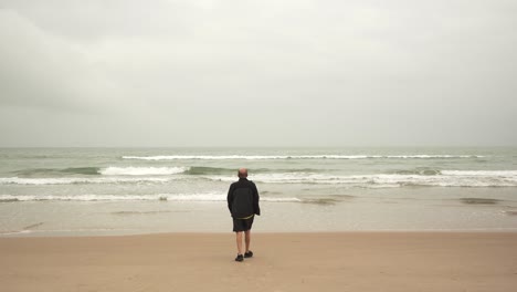 senior male athlete walking near sea