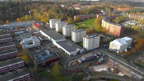 Beautiful-aerial-shot-of-Bergsjön-apartment-building-living-complex-and-construcion-site-with-beautiful-green-forest-in-the-distance