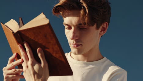 boy reading a book on a cloud