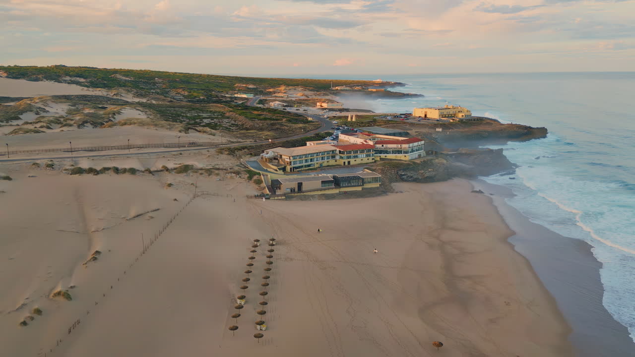 Aerial view beach complex at evening sunlight. Sunset sky over coastal nature