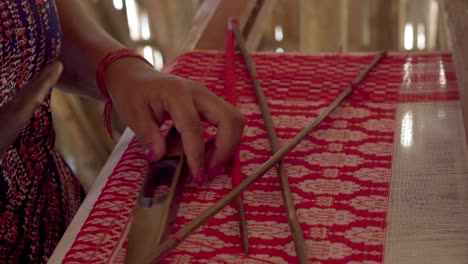 female-hands-labor-close-up-weaving-silk-cotton-in-workshop