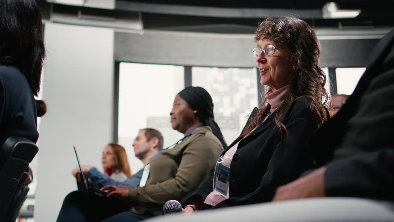 Senior woman in the audience interacting using microphone