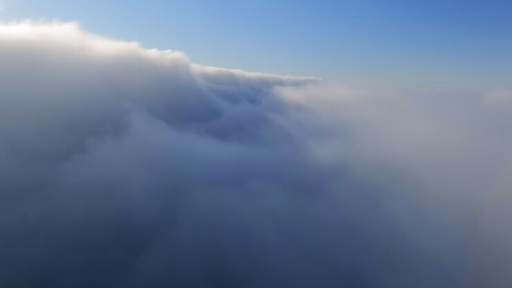 Flight Through Thick Cloudscape On A Foggy Morning Sky