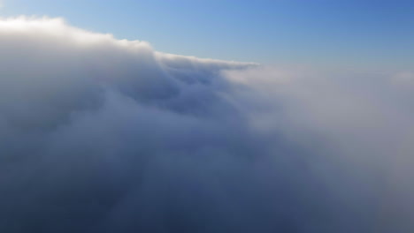 flight through thick cloudscape on a foggy morning sky
