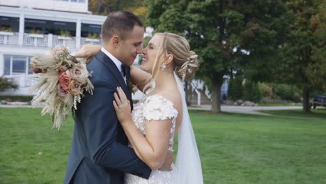 bride and groom laugh and kiss happily