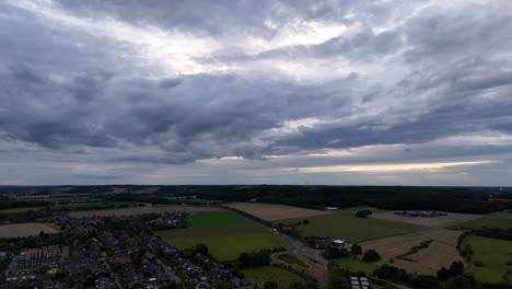 Dark cloudy day in American suburbia with highway and roundabout near agricultural farm fields. Small town with housing area and brick neighborhood. Pennsylvania, United States