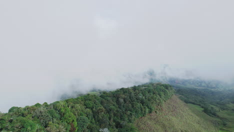 Breathtaking-aerial-view-of-misty-mountains-enveloped-in-ethereal-fog,-showcasing-the-stunning-beauty-of-nature-from-a-unique-perspective