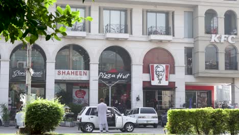 kfc, pizza hut, and other shops in a city