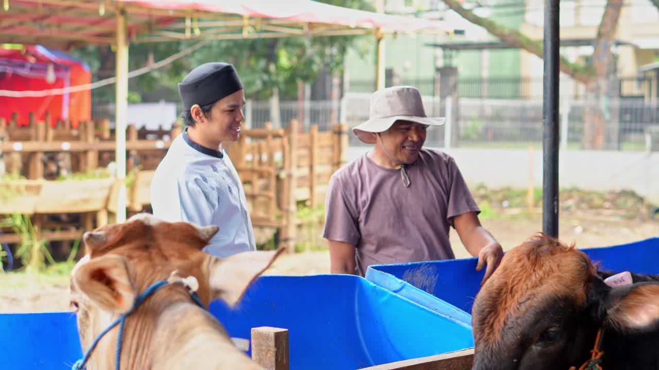 Muslim Man Paying Money To Farmer For Buying A Cow at The Cattle Farm For Islamic and Eid Al Adha Sacrifice Animal