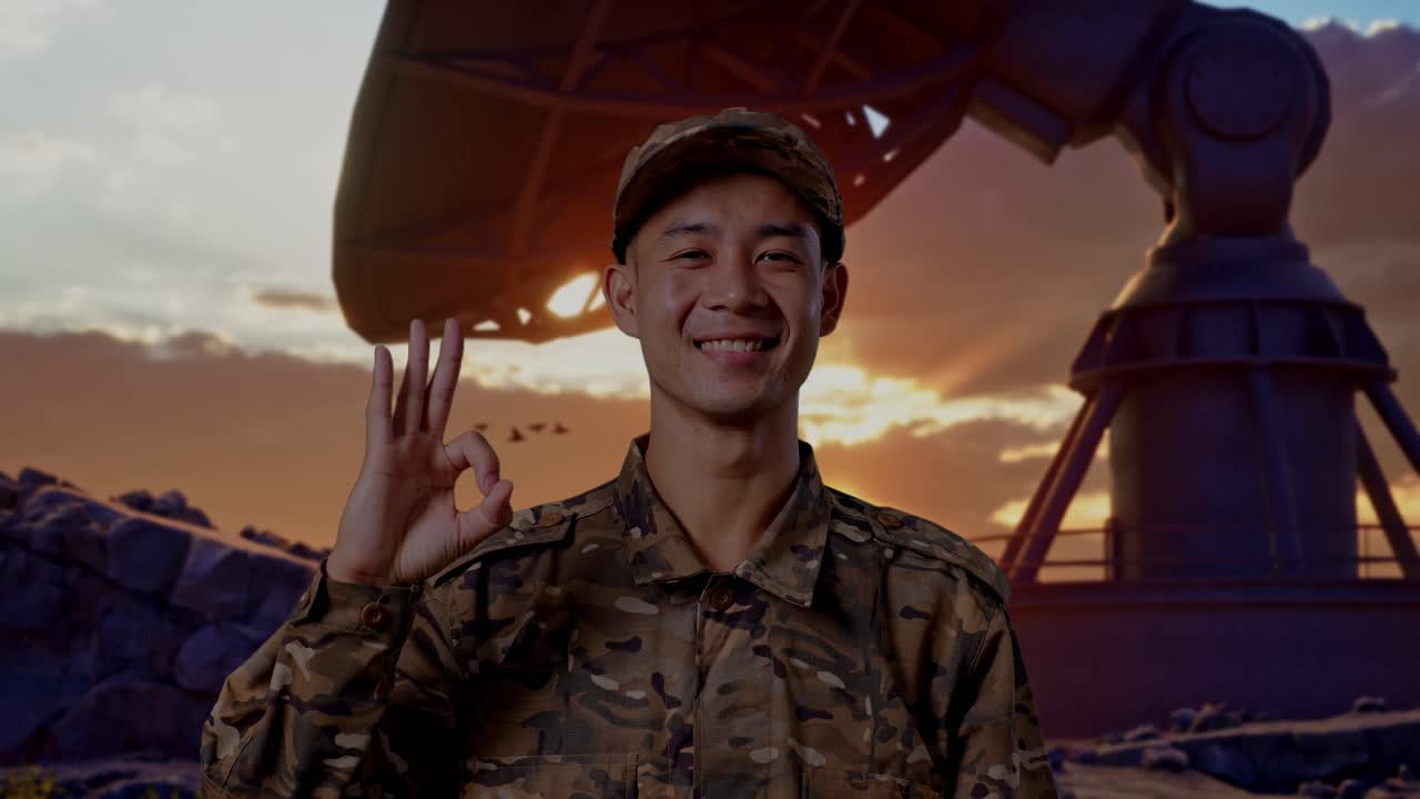 Close Up Of Asian Man Soldier Smiling And Showing Okay Gesture To Camera While Standing With Satellite Dish