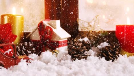 animation of snow falling over christmas decoration with pine cones