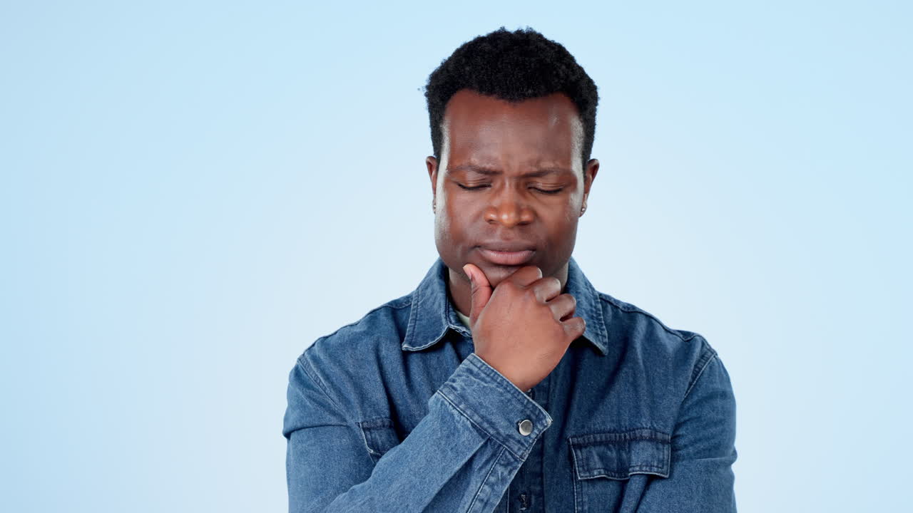 Man, confused and thinking in studio with doubt