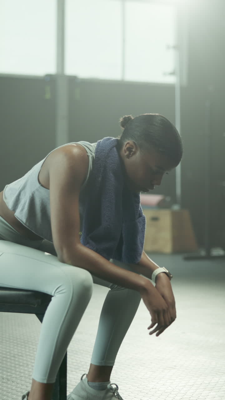 Young Black Woman Resting and Looking at Camera in Gym