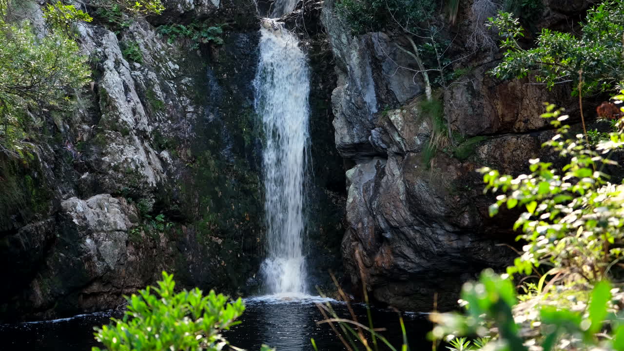 Falls plunge down mountain cliffside into pool, Disa Kloof Harold Porter
