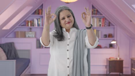 happy indian mother showing okay sign