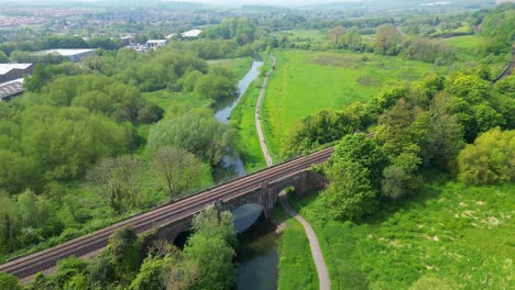 Crane-drone-shot-of-the-River-Stour-in-Canterbury-with-a-viaduct-crossing-over-it