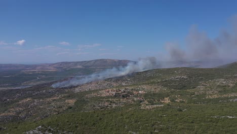 smokes rising from the wildfire at forest mountains in dalmatia, croatia