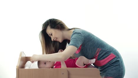 mother combing her baby hair