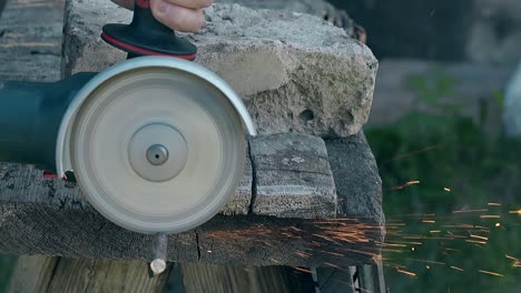 close view circular saw cuts piece of metal rod on table