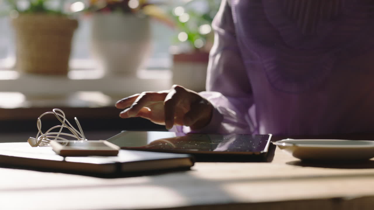 close up young woman hands using digital tablet computer in cafe drinking coffee browsing social media messages on touchscreen device enjoying mobile communication technology