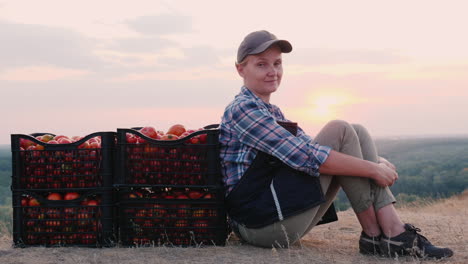 woman farmer resting after harvesting tomato