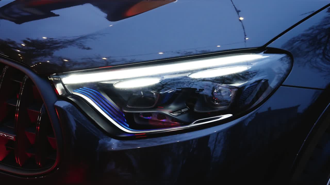 Close up of front headlight turn on, brand new car showcase event, Czechia