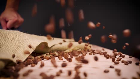 coffee beans dropped on table 4k slow motion