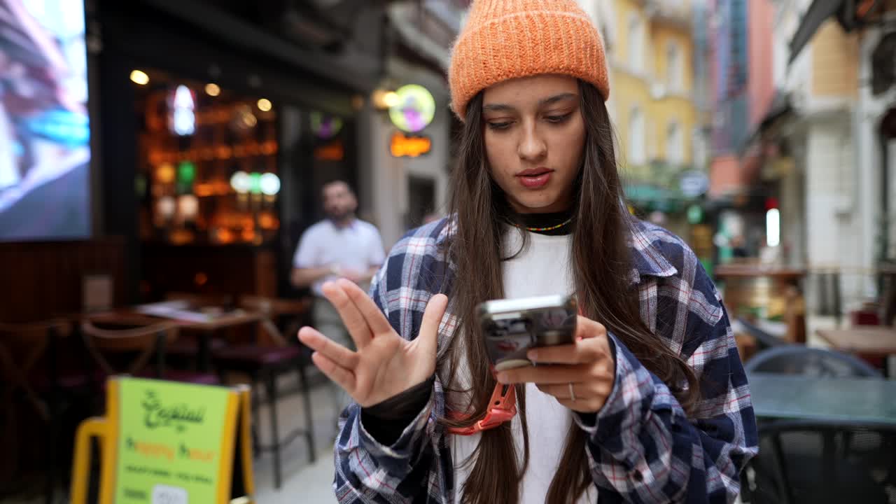 Young Woman Using Phone in City Street