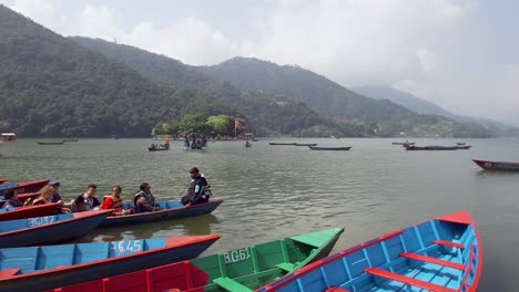 tourists arriving with boat at the waterfront after enjoying the phewa lake in pokhara, nepal