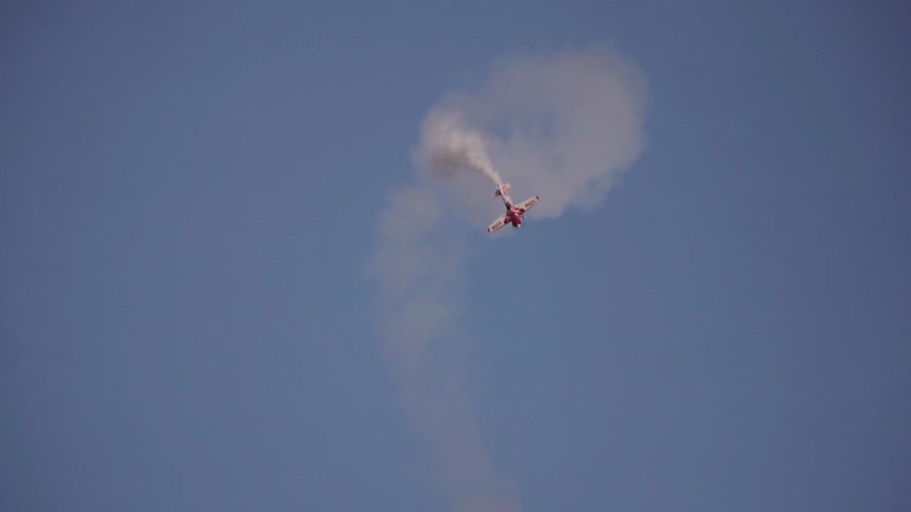 Acrobatic performance of airshow plane in the night with adrenatine driven effects, deadly loop