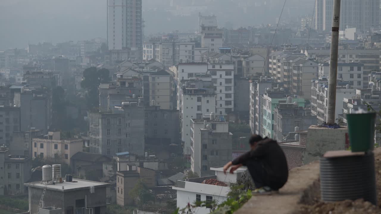 Contemplative Man Overlooking Smoggy City