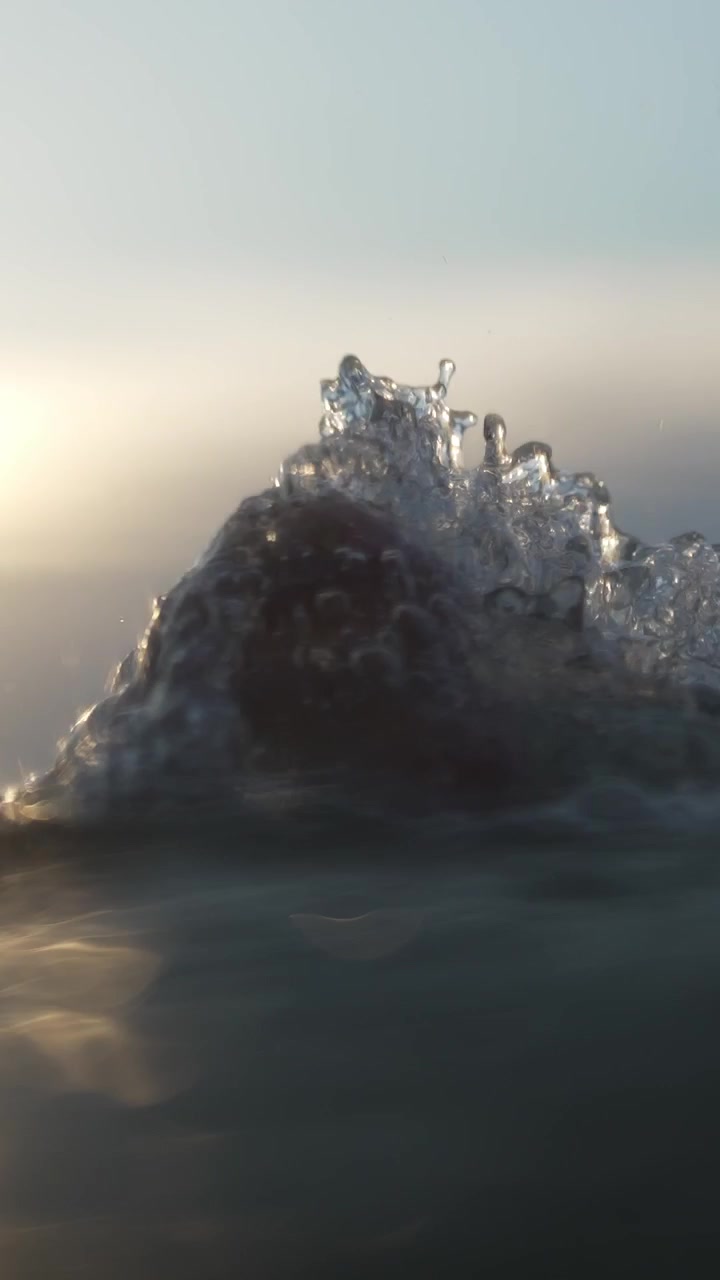Sunlight glistens through water, creating a shimmering effect on underwater waves. Ideal for nature documentaries or aquatic-themed projects.