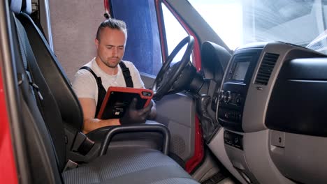 mechanic performing diagnostic check on a van