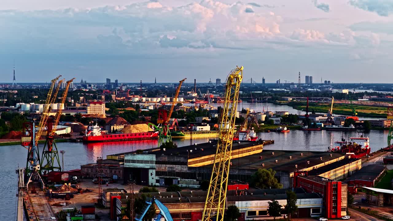 Daugava River Latvia port cargo industrial port shipping bulk material transport over water, aerial