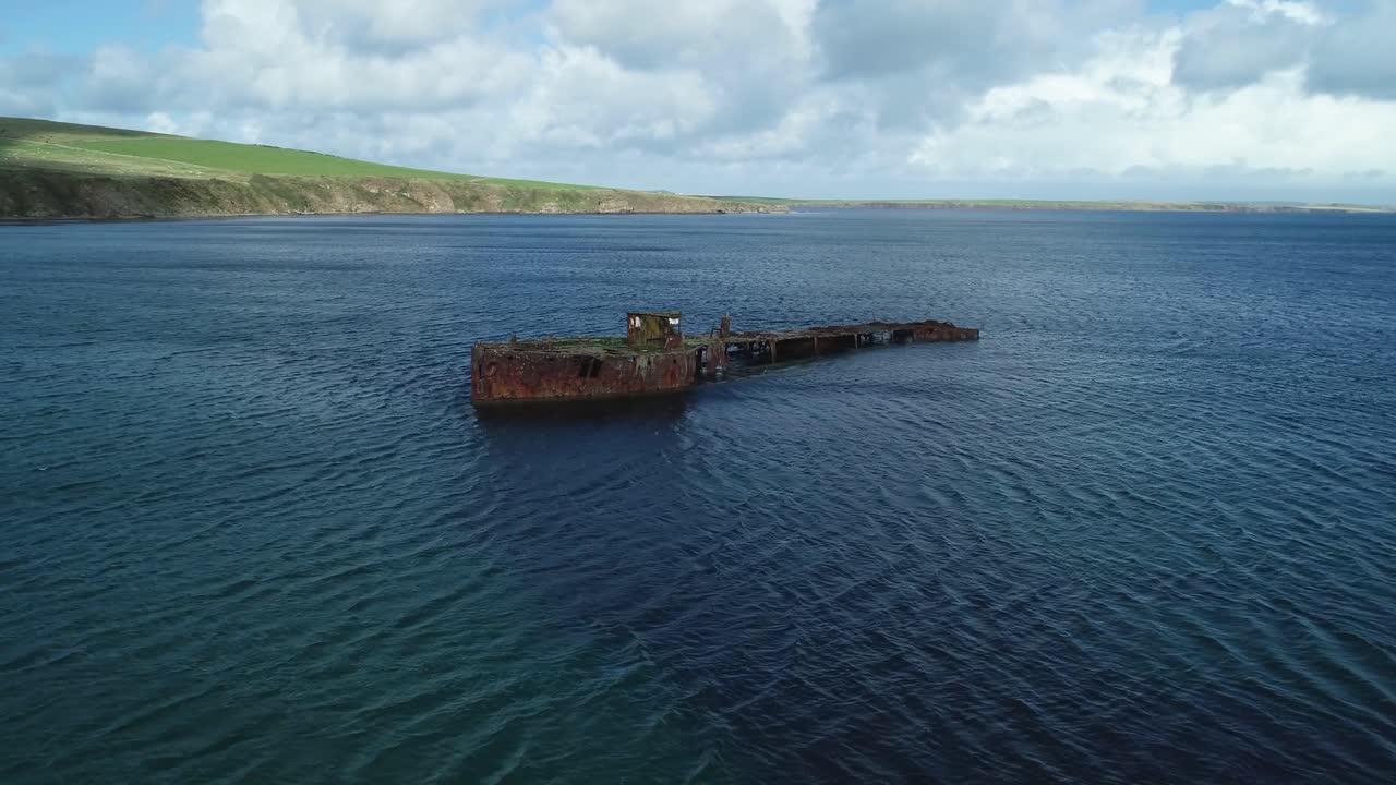 Aerial View of a Rusty Shipwreck on a Calm Ocean