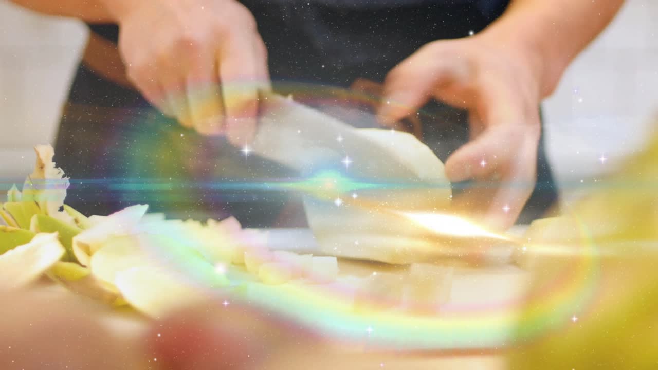 Chef placing artichokes on board slicing into cubes with knife sparkles flares drifting for cooking