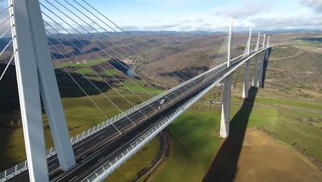 Close-flight-along-Millau-Viaduct-aerial-drone-shot-sunny-day