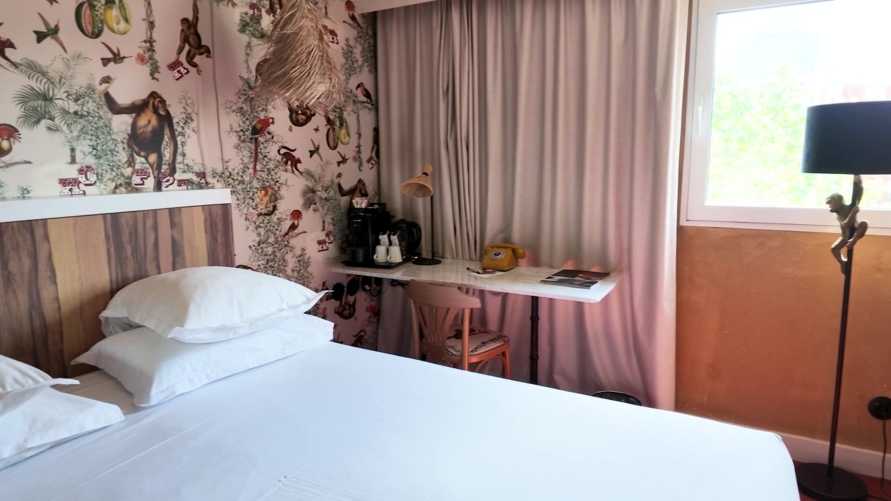 A slow panning shot of a stylish hotel room with vintage decor and natural lighting