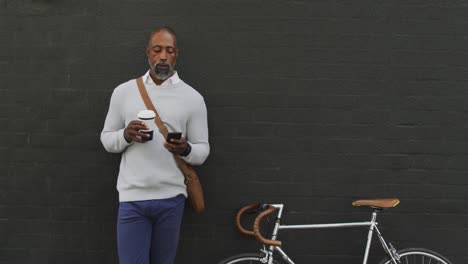 African-American-man-drinking-a-coffee-and-using-his-phone