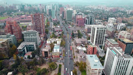 AERIAL:-Apoquindo-Avenue,-leading-to-the-Escuela-Militar-Subway-station,-in-Las-Condes,-Chile