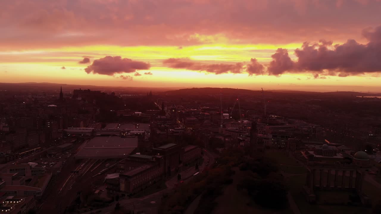 Aerial view of beautiful Edinburgh Scotland during dramatic sunset- Gaining altitude tilting camera down